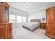 Spacious main bedroom with tray ceilings, plush carpet, and ample natural light from the large windows at 15792 Wiseman Dr, Fishers, IN 46040