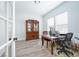 Bright home office with a wooden desk, cabinet, and natural light from the windows at 15792 Wiseman Dr, Fishers, IN 46040