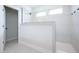 Modern walk-in shower with glass enclosure, white tiling, and black hardware, offering a luxurious experience at 15792 Wiseman Dr, Fishers, IN 46040