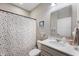 Bright bathroom featuring a vanity with quartz countertop and colorful polka dot shower curtain at 16270 Northwind Ct, Westfield, IN 46074