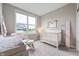 Tranquil Bedroom with soft colors, a crib, and a serene atmosphere, offering a nurturing space for your little one at 16270 Northwind Ct, Westfield, IN 46074