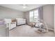 Cozy Bedroom with a crib, glider, and soft, natural light, creating a peaceful and comforting environment at 16270 Northwind Ct, Westfield, IN 46074