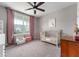 Charming Bedroom with pink accents, a crib, and a cozy chair, bathed in natural light from a large window at 16270 Northwind Ct, Westfield, IN 46074