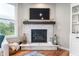 Close-up of the living room fireplace with stone surround and decorative mantel at 16270 Northwind Ct, Westfield, IN 46074