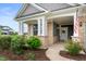 Welcoming covered front porch with decorative plants, columns, and an American flag at 16270 Northwind Ct, Westfield, IN 46074