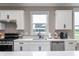 Close-up of the kitchen highlighting stainless steel appliances, countertops, and white cabinets at 16270 Northwind Ct, Westfield, IN 46074