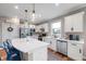 Modern kitchen featuring white cabinetry, an island with seating, stainless appliances, and sleek countertops at 16270 Northwind Ct, Westfield, IN 46074