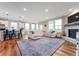 Bright, open living space featuring a large sectional sofa, stone fireplace, hardwood floors and an airy, modern design at 16270 Northwind Ct, Westfield, IN 46074