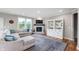 Cozy living room with a stone fireplace, built-in shelving, and a comfortable sectional sofa at 16270 Northwind Ct, Westfield, IN 46074