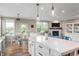 Open-concept living space with kitchen island, dining area, and cozy living room featuring a fireplace at 16270 Northwind Ct, Westfield, IN 46074