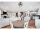 Open-concept kitchen, dining, and living room with hardwood flooring and a fireplace at 16270 Northwind Ct, Westfield, IN 46074