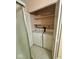 Inside of a bathroom showcasing a stacked washer and dryer and tiled flooring at 1639 Park Castle Way, Indianapolis, IN 46229