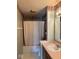This bathroom features a shower-tub combo with framed mirror and floral wallpaper trim at 1639 Park Castle Way, Indianapolis, IN 46229
