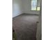 Bright bedroom with neutral carpet, white walls, and a window with blinds at 1639 Park Castle Way, Indianapolis, IN 46229