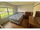 Bedroom with wood floors, large window, double bed, dresser, and mirror at 1639 Park Castle Way, Indianapolis, IN 46229