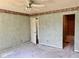 A spacious bedroom with painted walls and a vintage ceiling fan is awaiting personalization at 1639 Park Castle Way, Indianapolis, IN 46229