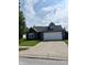 Charming single-story home featuring a spacious driveway, two-car garage, and well-maintained lawn at 1639 Park Castle Way, Indianapolis, IN 46229