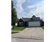 Charming one-story brick home with an attached two-car garage and well-manicured front lawn at 1639 Park Castle Way, Indianapolis, IN 46229