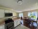 Kitchen that opens into the living and dining area; stainless steel appliances and white cabinets at 1639 Park Castle Way, Indianapolis, IN 46229
