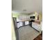 Well-lit kitchen with white cabinetry and stainless steel appliances, including a range and refrigerator at 1639 Park Castle Way, Indianapolis, IN 46229
