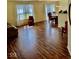 Bright living room featuring hardwood floors, large windows and sliding glass doors for natural light and easy access at 1639 Park Castle Way, Indianapolis, IN 46229