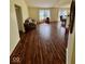 Spacious living room with hardwood floors, providing a view into the dining and kitchen area at 1639 Park Castle Way, Indianapolis, IN 46229