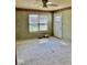 A bright living room with a window, door to the exterior, and neutral carpet awaits your touch at 1639 Park Castle Way, Indianapolis, IN 46229