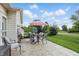 Enjoy the outdoors on this beautiful back patio that features a dining set and lush green surroundings at 1663 Sweetgum Dr, Greenwood, IN 46143