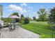 View of the backyard patio with dining set, overlooking the lush green lawn at 1663 Sweetgum Dr, Greenwood, IN 46143