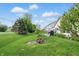 Serene backyard with lush greenery and patio, perfect for outdoor relaxation and entertaining at 1663 Sweetgum Dr, Greenwood, IN 46143