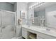 Bathroom featuring double sinks, a large mirror, and a glass enclosed shower at 1663 Sweetgum Dr, Greenwood, IN 46143