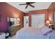 Bedroom featuring red walls, ceiling fan, and dresser at 1663 Sweetgum Dr, Greenwood, IN 46143