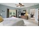 The bedroom features a large window, wood dresser, and a ceiling fan to maximize comfort and style at 1663 Sweetgum Dr, Greenwood, IN 46143