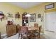 The dining area has seating for six, a decorative hutch, and natural lighting at 1663 Sweetgum Dr, Greenwood, IN 46143