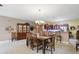 A dining area with a hutch, seating for six, and a view into the kitchen and breakfast bar area at 1663 Sweetgum Dr, Greenwood, IN 46143