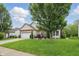 Charming brick and siding home features a well-manicured lawn and a two-car garage at 1663 Sweetgum Dr, Greenwood, IN 46143