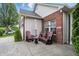 Inviting front porch with cozy seating, charming brick accents and stamped concrete at 1663 Sweetgum Dr, Greenwood, IN 46143