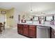 This is a kitchen area with wood cabinets, stainless steel appliances, and a granite countertop island at 1663 Sweetgum Dr, Greenwood, IN 46143