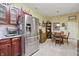 An eat-in kitchen features stainless steel appliances, wood cabinets, a tiled floor and plenty of natural light at 1663 Sweetgum Dr, Greenwood, IN 46143