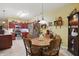 Eat-in kitchen features warm yellow walls, a wood table with seating, wood cabinets, and stainless steel appliances at 1663 Sweetgum Dr, Greenwood, IN 46143