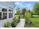 The home's side yard boasts a charming stone walkway and lush flower gardens, adding to the property's charm at 1663 Sweetgum Dr, Greenwood, IN 46143