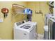 This laundry room has a modern washing machine with overhead storage, set against cheerful yellow walls at 1663 Sweetgum Dr, Greenwood, IN 46143