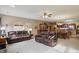 Open-concept living room featuring dual leather sofas and seamless flow into the kitchen and dining area at 1663 Sweetgum Dr, Greenwood, IN 46143