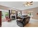 Cozy living room with fireplace, leather seating, and ample natural light at 1663 Sweetgum Dr, Greenwood, IN 46143