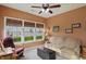 Relaxing sunroom with multiple windows, cozy seating, and charming decor for a tranquil retreat at 1663 Sweetgum Dr, Greenwood, IN 46143