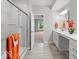 Elegant bathroom featuring a glass enclosed shower, double vanity, and stylish orange accent towels and flowers at 16739 Cattle Hollow Ln, Noblesville, IN 46060