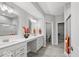 Modern bathroom boasts dual sinks, sleek countertops, wood-look tile flooring and walk-in shower at 16739 Cattle Hollow Ln, Noblesville, IN 46060