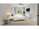 Stylishly furnished bedroom features large window, ceiling fan, TV, and is decorated in a neutral color palette at 16739 Cattle Hollow Ln, Noblesville, IN 46060