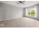 Spacious bedroom features a ceiling fan, neutral gray walls, plush carpet, and a window for ample natural light at 16739 Cattle Hollow Ln, Noblesville, IN 46060