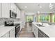 Well-equipped kitchen with stainless steel appliances and a breakfast bar overlooking the living area at 16739 Cattle Hollow Ln, Noblesville, IN 46060